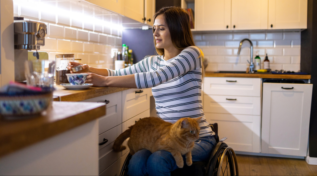 Woman,In,Wheelchair,In,Kitchen,At,Home